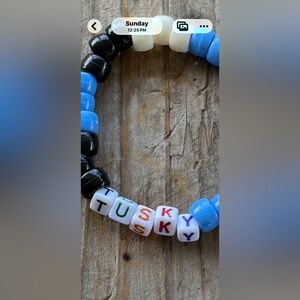 Utah mammoth mascot name bracelet says tusky with black blue and white beads.